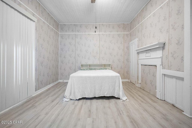 unfurnished bedroom with ornamental molding and light hardwood / wood-style floors