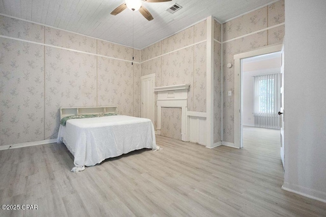 unfurnished bedroom with ceiling fan, wood ceiling, and light hardwood / wood-style floors