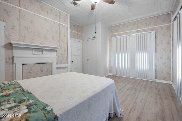 bedroom with ceiling fan and wood-type flooring