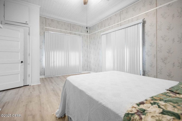 bedroom with ceiling fan, hardwood / wood-style floors, and crown molding