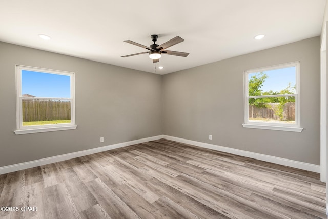 unfurnished room with recessed lighting, baseboards, and wood finished floors