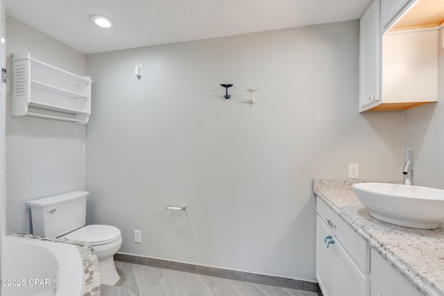 bathroom featuring toilet and vanity