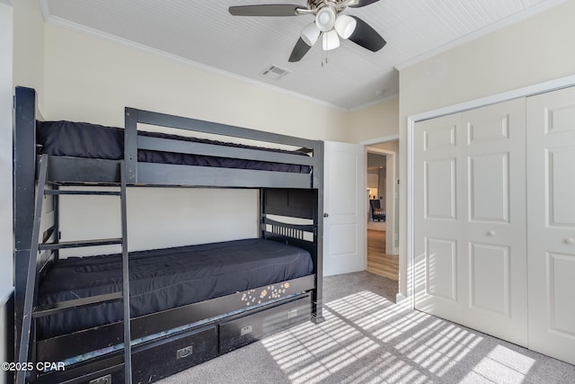 bedroom with carpet floors, ceiling fan, and a closet