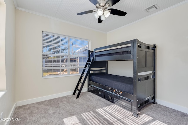 bedroom with ornamental molding, ceiling fan, and carpet flooring