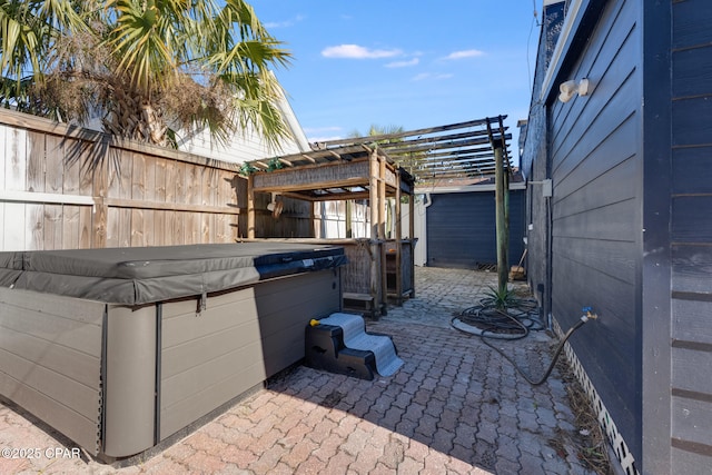 view of patio featuring a hot tub and a pergola