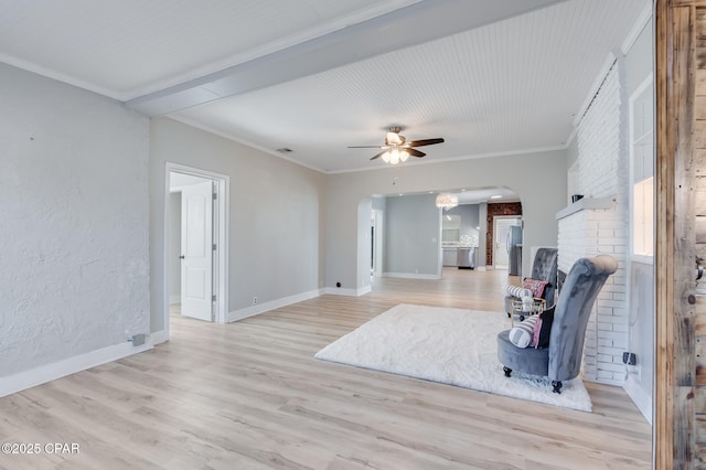 living room with light hardwood / wood-style floors, ceiling fan, and crown molding