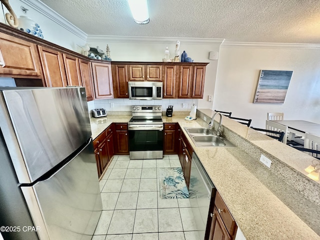 17643 Front Beach Rd Unit 1806, Panama City Beach, FL 32413 - kitchen with stainless steel appliances, a sink, light tile patterned flooring, a peninsula, and a textured ceiling