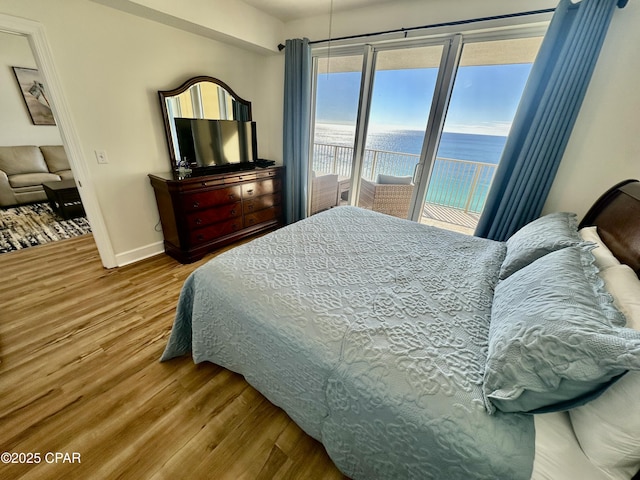 17643 Front Beach Rd Unit 1806, Panama City Beach, FL 32413 - bedroom with baseboards, wood finished floors, and access to exterior