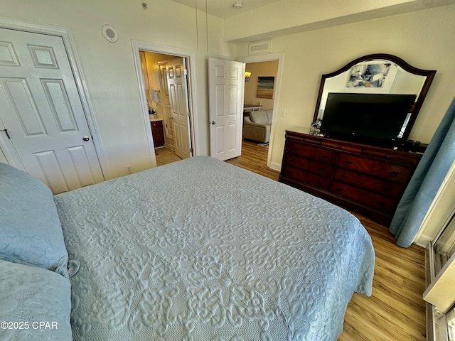 17643 Front Beach Rd Unit 1806, Panama City Beach, FL 32413 - bedroom with wood finished floors, visible vents, and connected bathroom