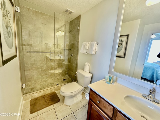 bathroom featuring toilet, vanity, tile patterned floors, a textured ceiling, and an enclosed shower