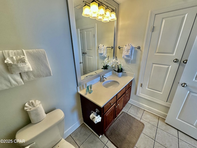 bathroom with toilet, tile patterned floors, and vanity