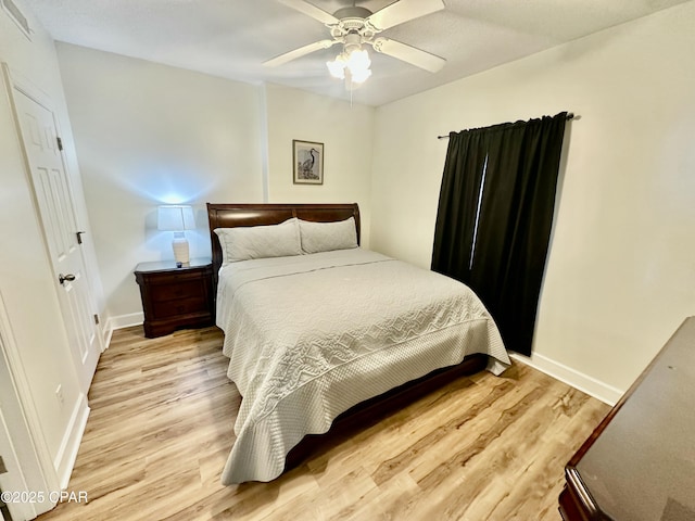 bedroom with ceiling fan and light hardwood / wood-style flooring