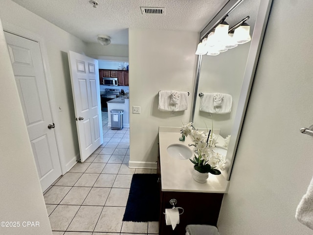 bathroom featuring vanity, tile patterned flooring, a notable chandelier, and a textured ceiling