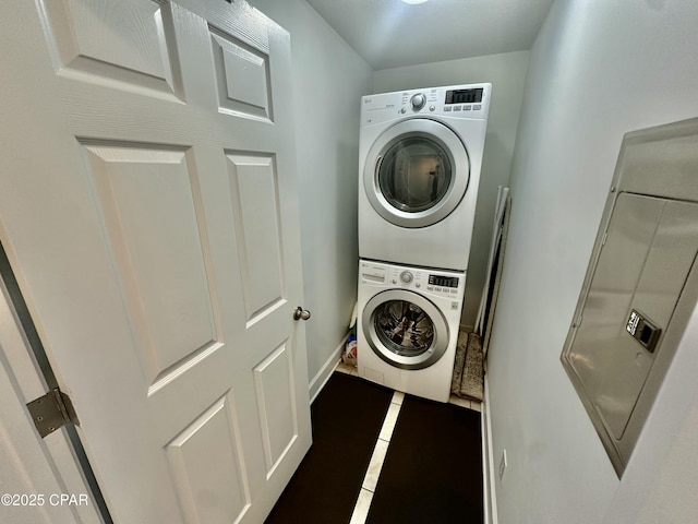 washroom featuring stacked washer and dryer