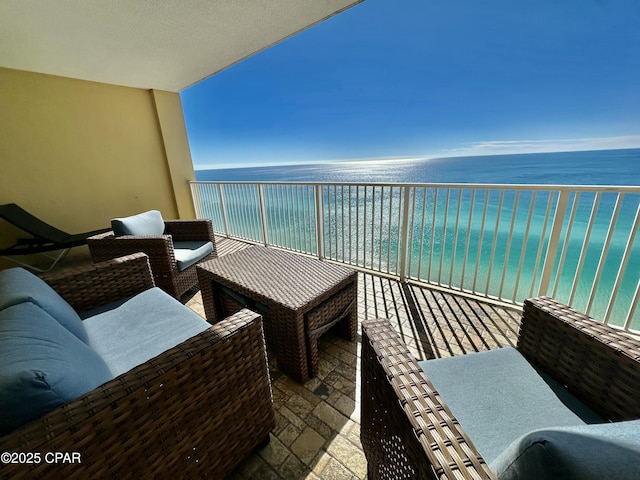 balcony featuring a water view and outdoor lounge area