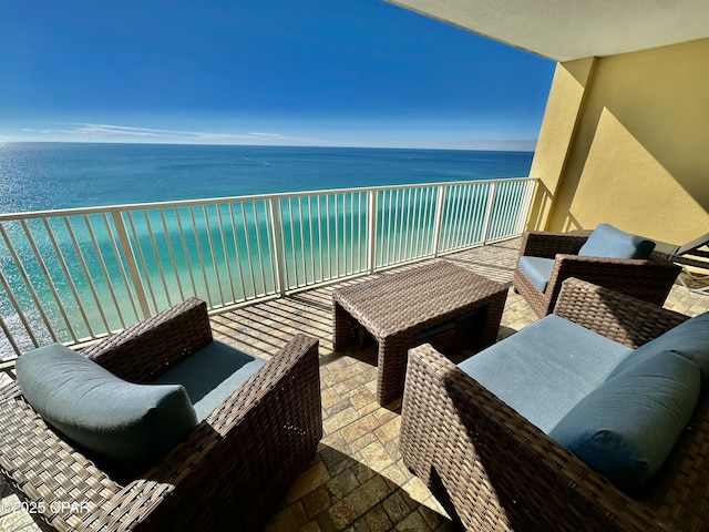 balcony with an outdoor hangout area and a water view