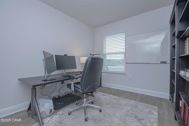 home office with hardwood / wood-style flooring