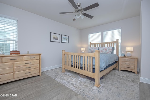 bedroom with light hardwood / wood-style floors and ceiling fan