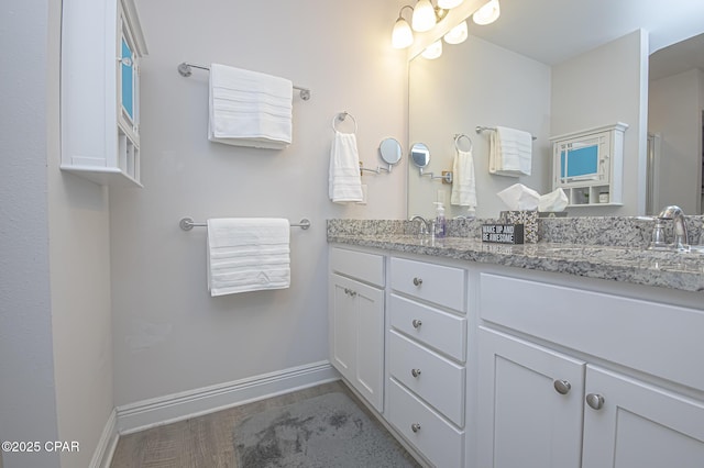 bathroom with vanity and hardwood / wood-style flooring