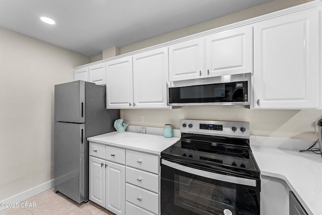 kitchen featuring white cabinetry, appliances with stainless steel finishes, and light tile patterned floors