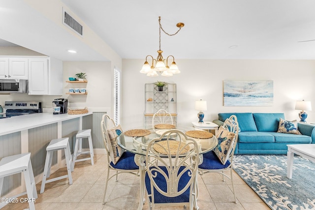 dining area featuring a chandelier and light tile patterned floors