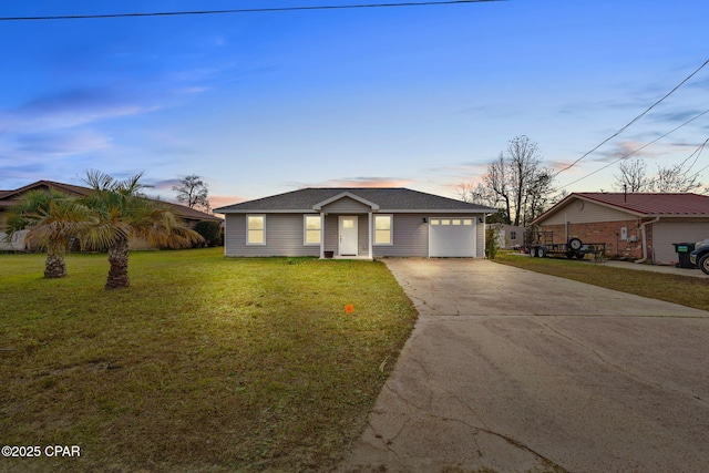 ranch-style home with a garage and a yard