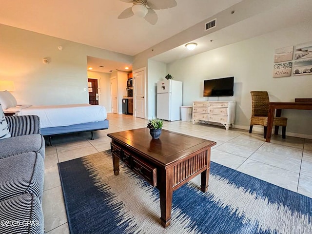 interior space featuring ceiling fan and white fridge