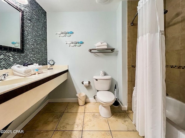 full bathroom featuring shower / tub combo with curtain, tile patterned floors, toilet, sink, and tasteful backsplash