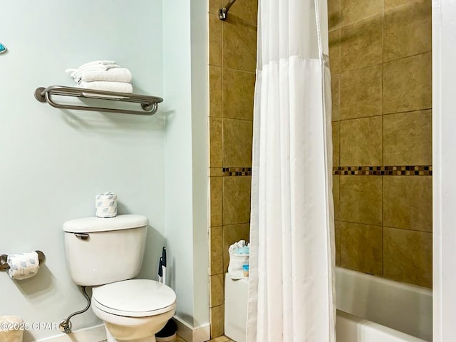 bathroom with shower / bath combo and toilet