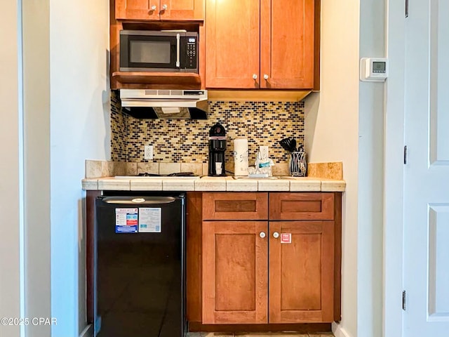 kitchen featuring tasteful backsplash and tile countertops