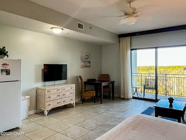 bedroom featuring access to exterior, light tile patterned floors, ceiling fan, and white refrigerator