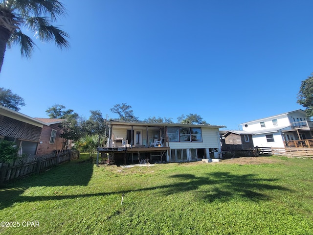 rear view of property with a lawn