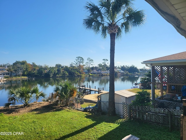 dock area featuring a water view and a lawn