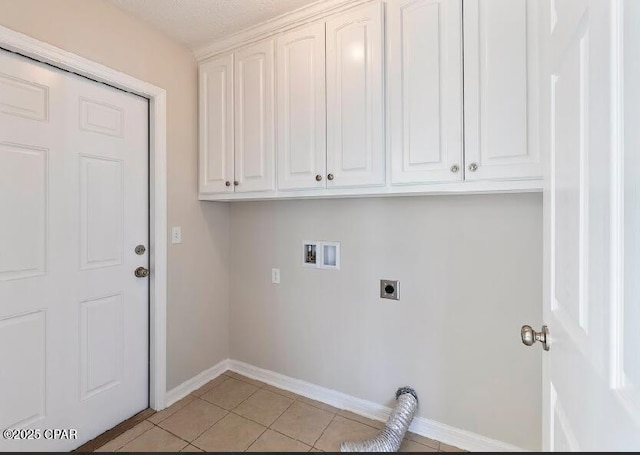 laundry room featuring light tile patterned flooring, a textured ceiling, cabinets, hookup for a washing machine, and hookup for an electric dryer