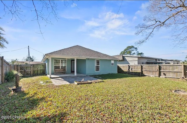 back of property featuring a lawn and a patio