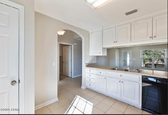 kitchen featuring light tile patterned floors, sink, white cabinetry, and black dishwasher