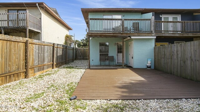 rear view of property with a wooden deck