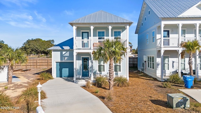 coastal home featuring a garage and a balcony