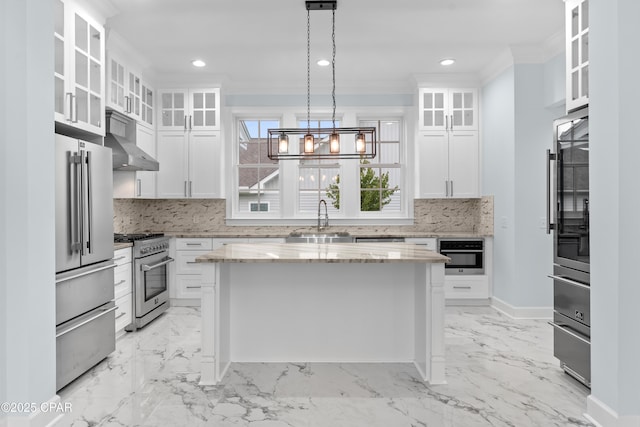 kitchen featuring white cabinets, crown molding, and premium appliances