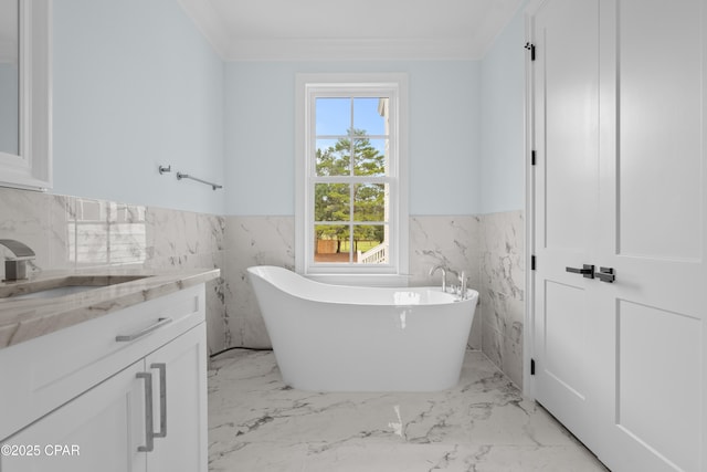 bathroom featuring vanity, tile walls, ornamental molding, and a tub