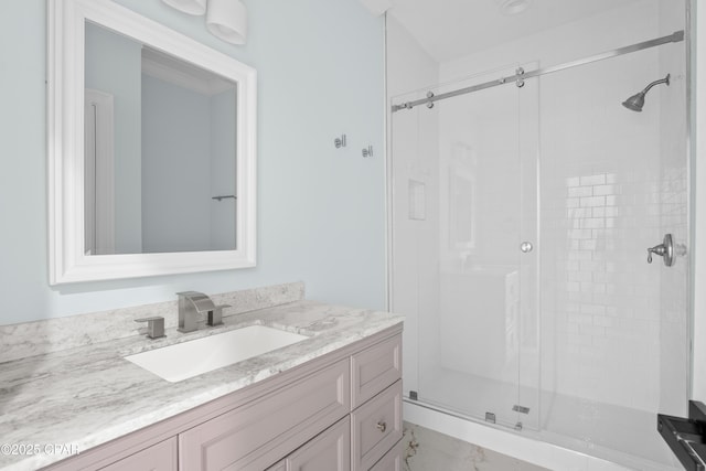 bathroom with a shower with door and vanity