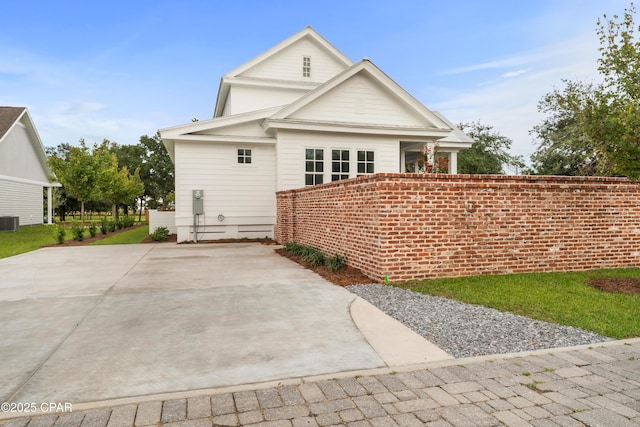 rear view of house featuring central AC