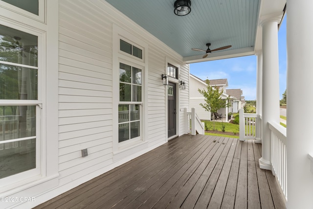 wooden deck with covered porch and ceiling fan