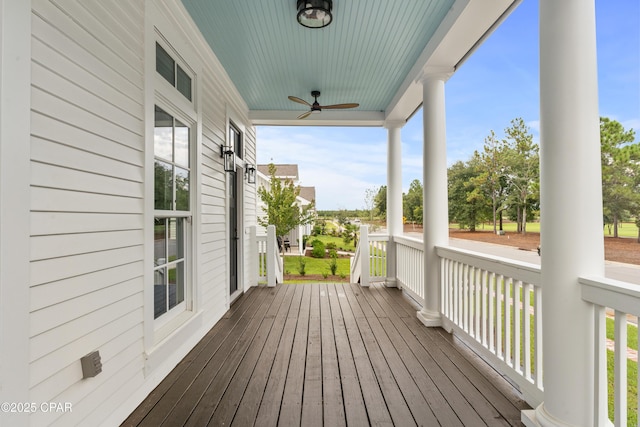 deck with ceiling fan and covered porch