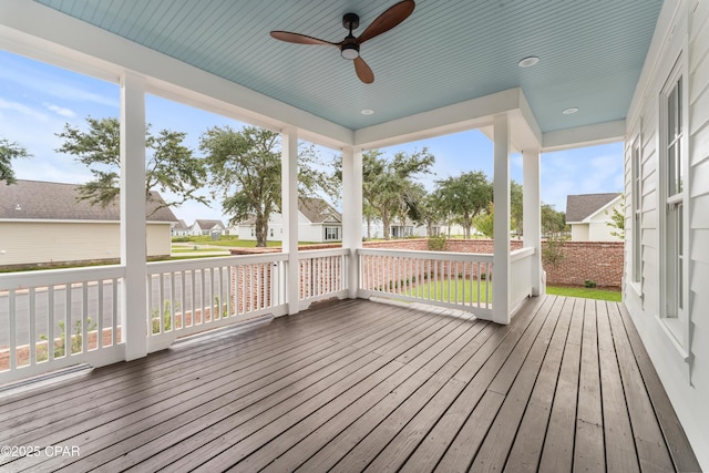 unfurnished sunroom featuring ceiling fan