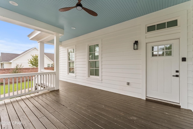 wooden deck featuring ceiling fan