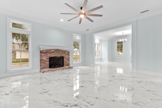 unfurnished living room featuring ceiling fan with notable chandelier, a fireplace, ornamental molding, and plenty of natural light