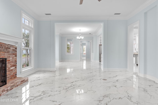 unfurnished living room with ornamental molding, ceiling fan with notable chandelier, and a fireplace