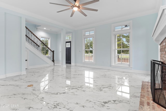 unfurnished living room with ornamental molding and ceiling fan