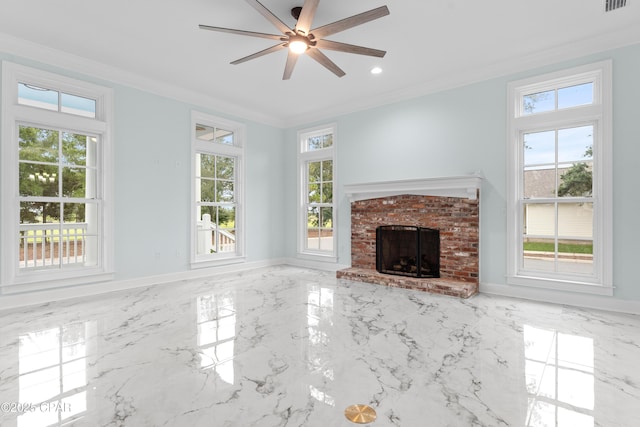 unfurnished living room featuring a fireplace, ornamental molding, ceiling fan, and plenty of natural light